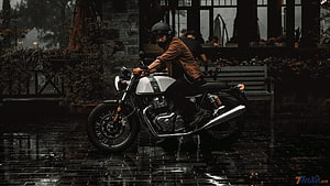 Retro Triumph Motorcycle Rider on Wet Cobblestone Street HD wallpaper