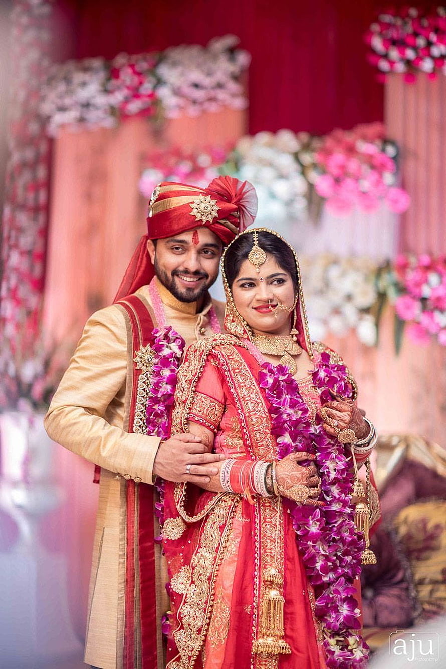 Indian Bride and Groom in Traditional Red and Gold Wedding Attire with Floral Garlands HD phone wallpaper