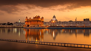 Golden Temple Amritsar at Sunset with Reflections in the Holy Sarovar Pool HD wallpaper