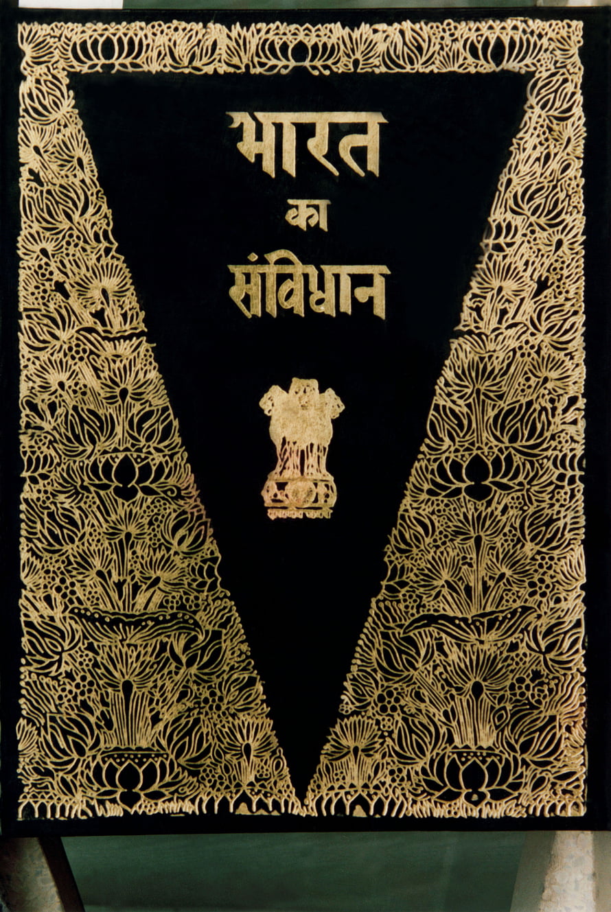 Ornate Black and Gold Cover of the Indian Constitution Book with National Emblem HD phone wallpaper