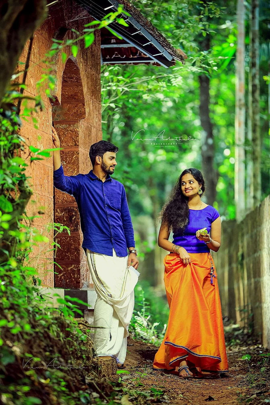 Indian couple in traditional attire posing in a lush green forest setting HD phone wallpaper