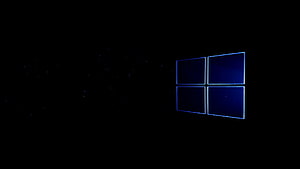 Windows 11 Default Dark Blue Wallpaper with Glowing Logo and Particles HD wallpaper
