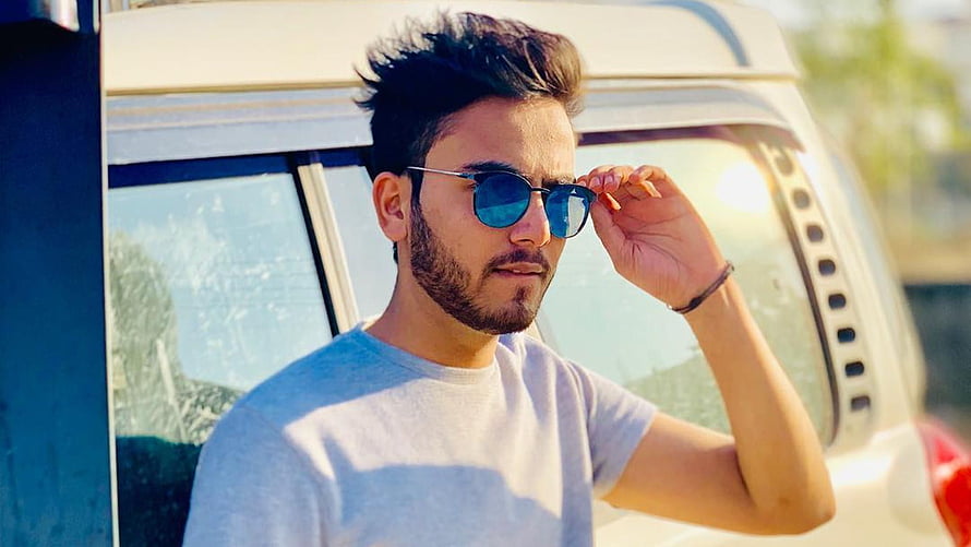 Elvish Yadav Wearing Blue Sunglasses in Front of a White Van HD wallpaper