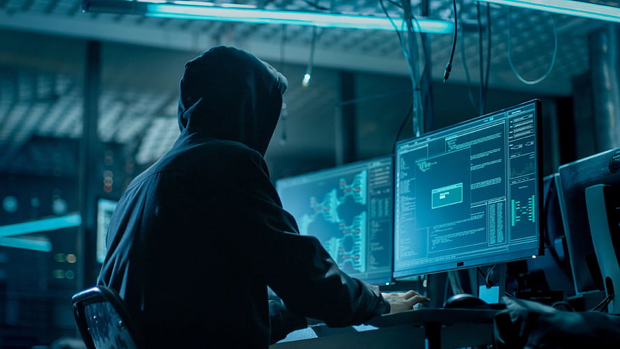 Anonymous Hacker in Hoodie Working on Multiple Computer Monitors in Dark Cyber Security Room HD wallpaper