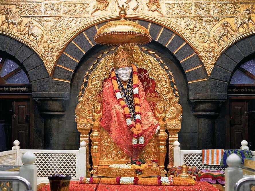 Golden Statue of Sai Baba of Shirdi Seated on Ornate Throne in Temple Shrine HD wallpaper