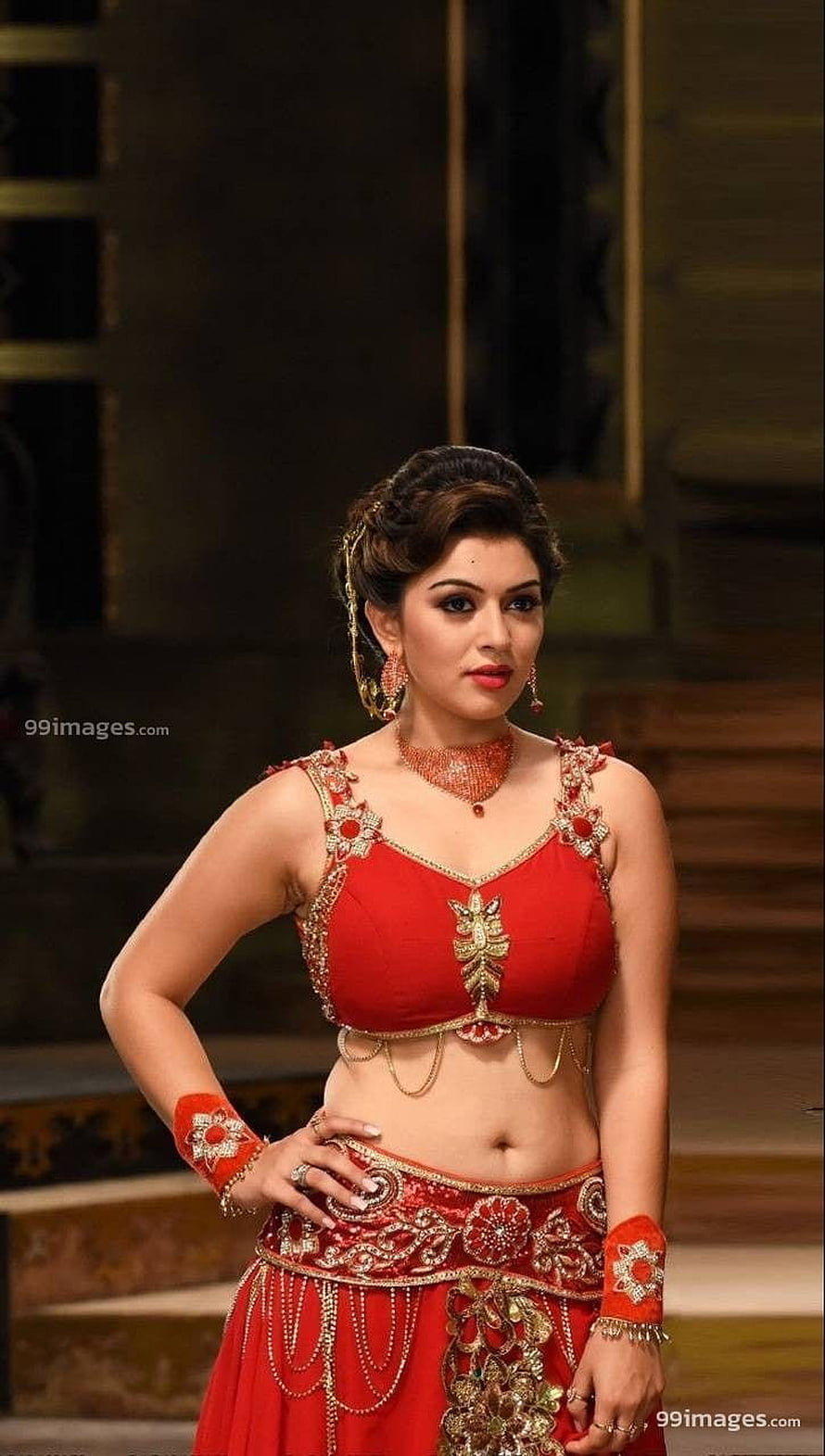 Hansika Motwani in a stunning red traditional lehenga choli with gold embroidery and jewelry HD phone wallpaper