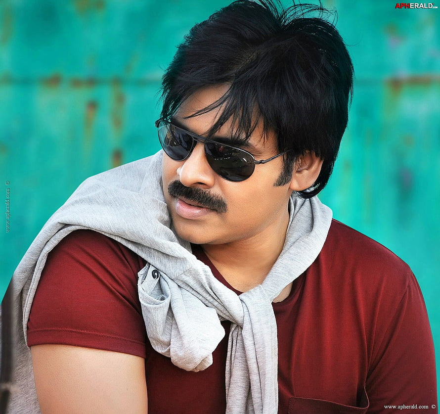 Pawan Kalyan in aviator sunglasses with a grey scarf draped over a maroon t-shirt against a teal backdrop HD wallpaper