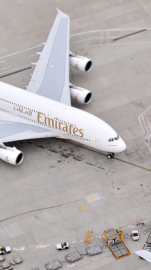 Emirates Airbus A380 Wide-Body Jet Parked on Airport Tarmac with Ground Crew HD phone wallpaper