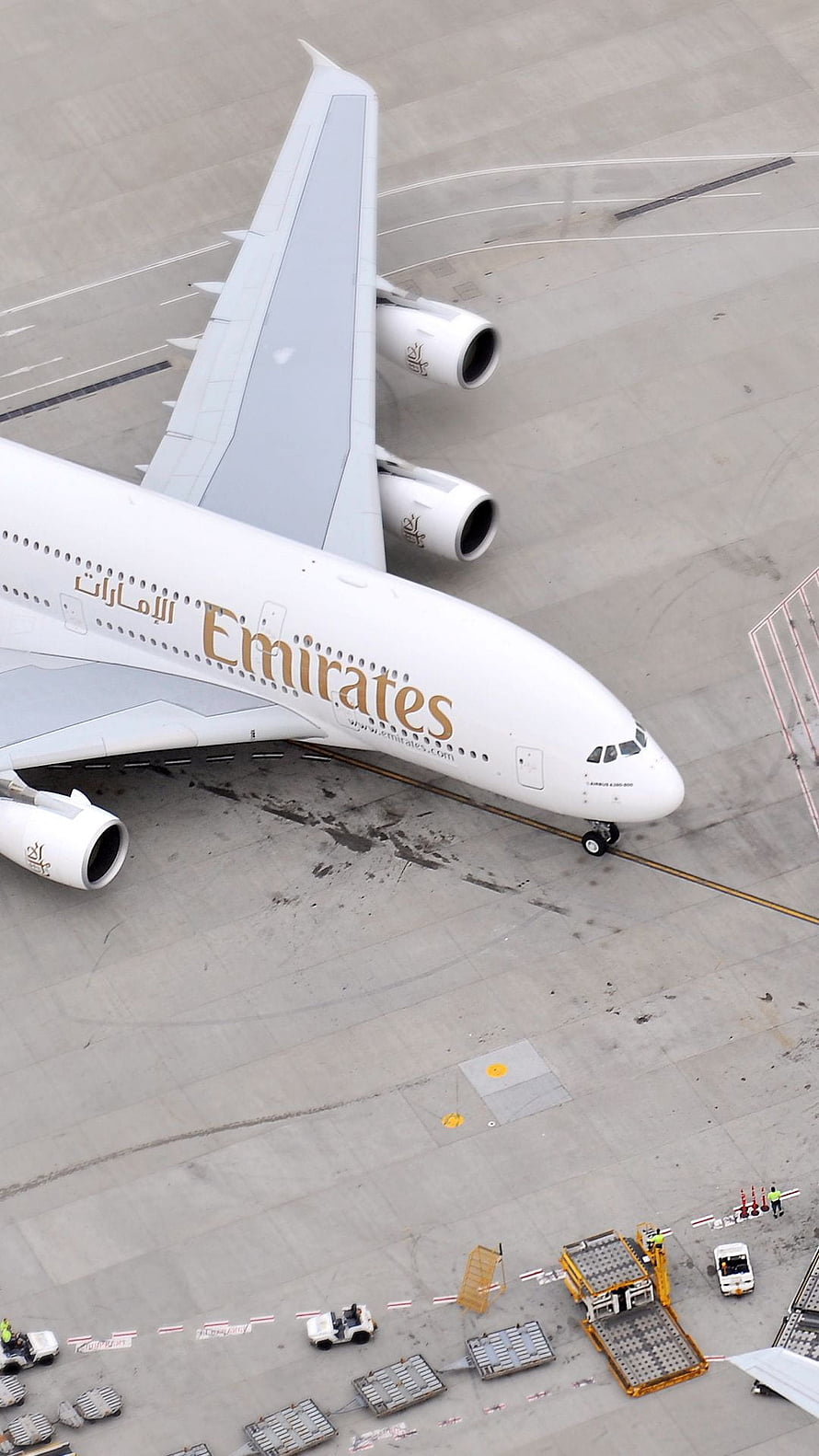 Emirates Airbus A380 Wide-Body Jet Parked on Airport Tarmac with Ground Crew HD phone wallpaper