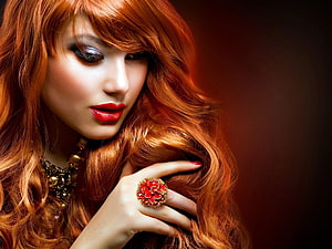 Portrait of a woman with long wavy red hair, bold red lipstick, and a large ornate red ring against a dark background, 6 Beauty Salon, women hair salon HD wallpaper