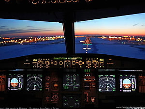 Airbus A320 Cockpit View During Sunset Approach Over Illuminated City HD wallpaper
