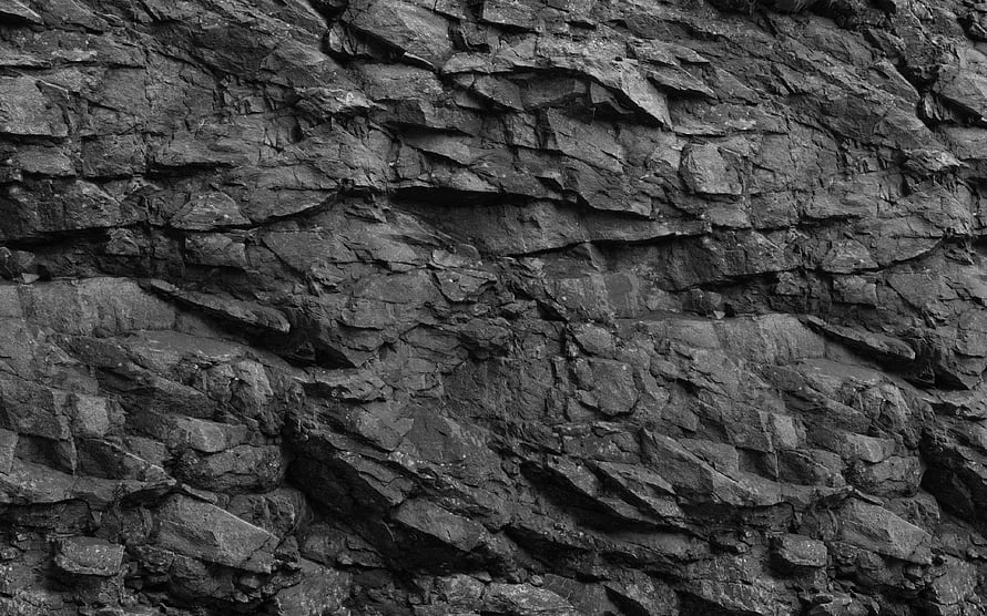 Dark Layered Rock Face Texture with Deep Rugged Surface Details HD wallpaper