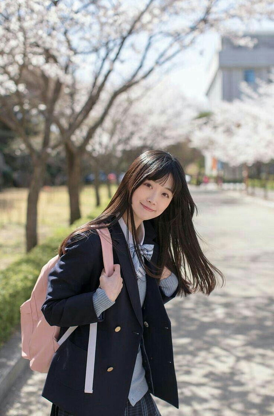 Japanese Schoolgirl in Blazer and Plaid Skirt Walking Under Cherry Blossoms HD phone wallpaper