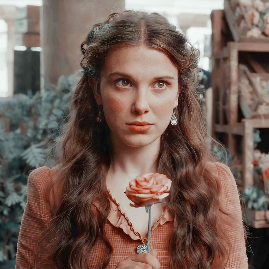 Enola Holmes holding a rose in a vintage floral shop setting HD phone wallpaper