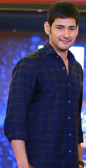 Mahesh Babu in a dark plaid shirt at a Tollywood event with a blue bokeh background HD phone wallpaper