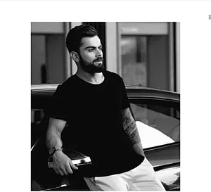 Virat Kohli in Black T-Shirt Leaning Against Car in Monochrome Portrait HD wallpaper