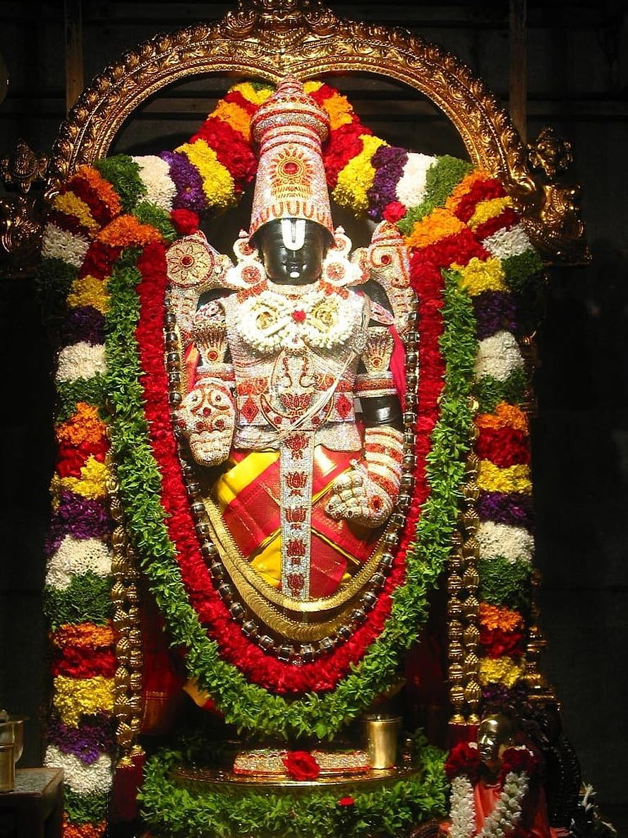 Decorated Hindu Deity Statue with Colorful Flower Garlands and Golden Crown HD phone wallpaper