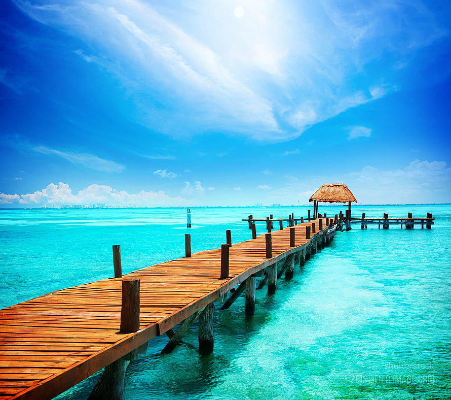 Tropical Wooden Pier Extending Into Turquoise Ocean Water Under a Bright Blue Sky HD wallpaper