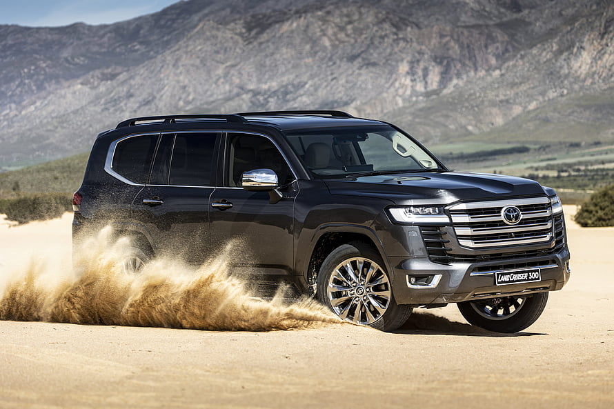 Black Toyota Land Cruiser 300 Series SUV Driving on Dusty Off-Road Terrain HD wallpaper