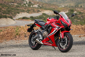 Red Honda CBR650R Sport Motorcycle Parked on Gravel Road with Mountainous Background HD wallpaper