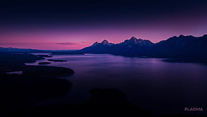 Aerial View of a Serene Mountain Lake at Twilight with a Vibrant Purple Sky HD wallpaper