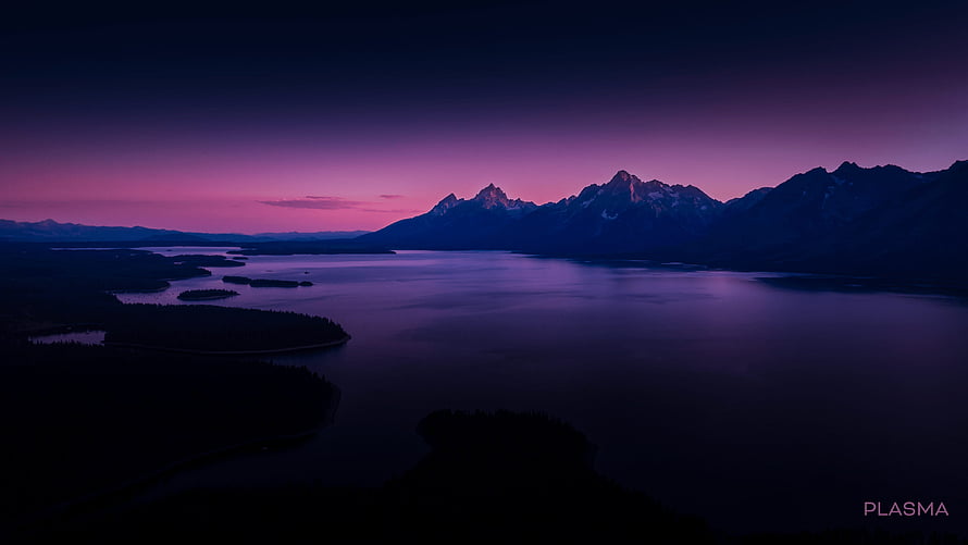 Aerial View of a Serene Mountain Lake at Twilight with a Vibrant Purple Sky HD wallpaper