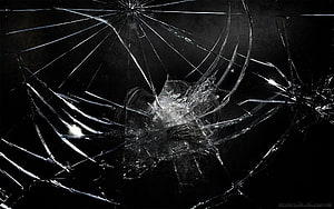 Shattered Glass Texture with Radiating Fracture Lines on Black Background HD wallpaper