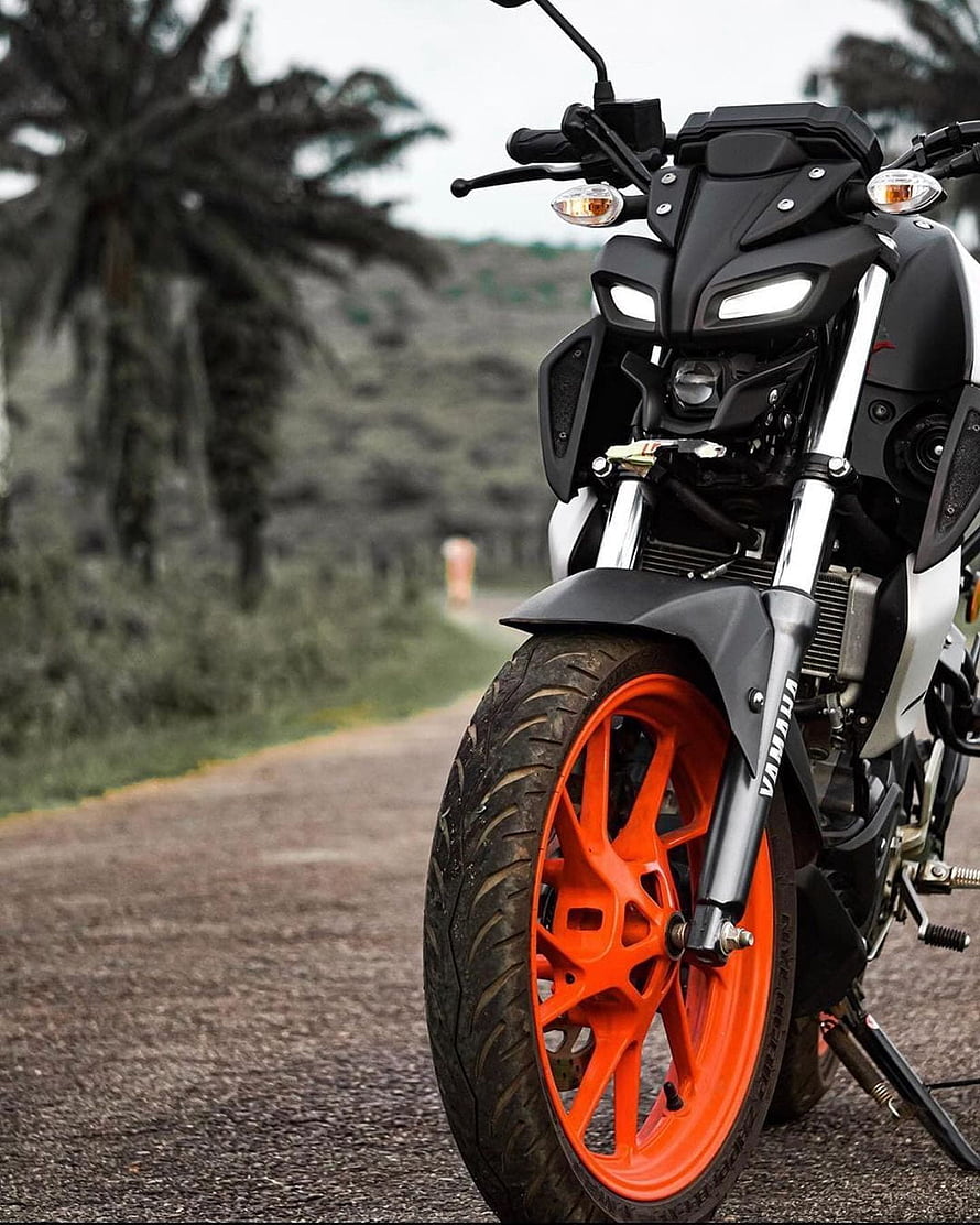 Yamaha MT-15 motorcycle with custom orange wheels parked on a rural road HD phone wallpaper