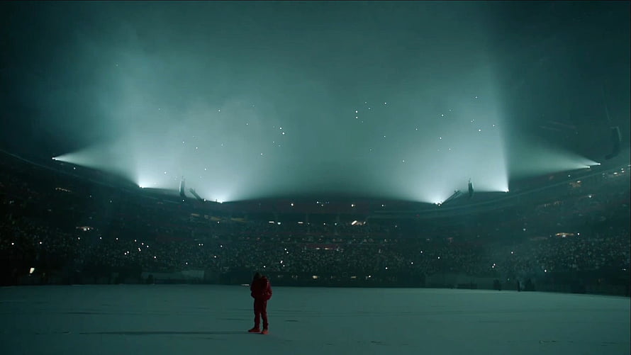 Kanye West Performing on a Snow-Covered Stadium Stage Under Dramatic Green Spotlights HD wallpaper