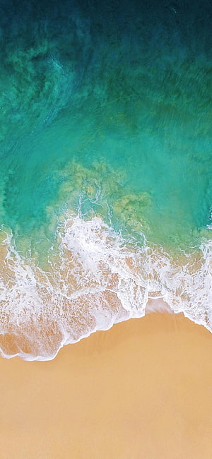Aerial View of Turquoise Ocean Waves Crashing on Golden Sandy Beach HD phone wallpaper