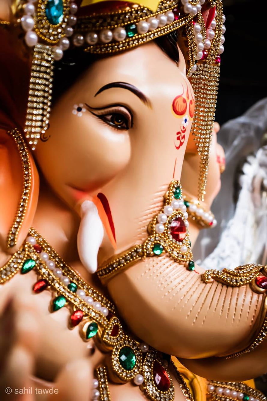 Ornate Ganesha Murti Close-Up with Jeweled Crown and Gemstone Adornments HD phone wallpaper