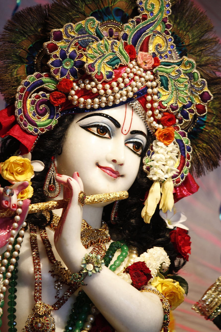 Ornate Krishna Idol Playing Flute with Peacock Feather Crown and Floral Jewelry HD phone wallpaper