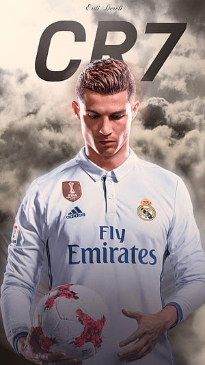 Cristiano Ronaldo in Real Madrid Kit Holding Soccer Ball with Dramatic Cloud Background HD phone wallpaper