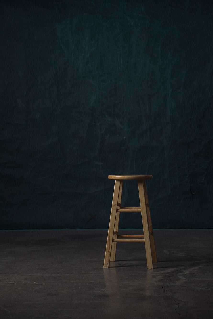 Minimalist Wooden Stool on Dark Textured Background HD phone wallpaper