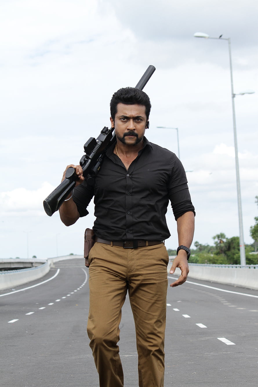 Suriya in Singam Action Still Walking on Highway with Sniper Rifle HD phone wallpaper