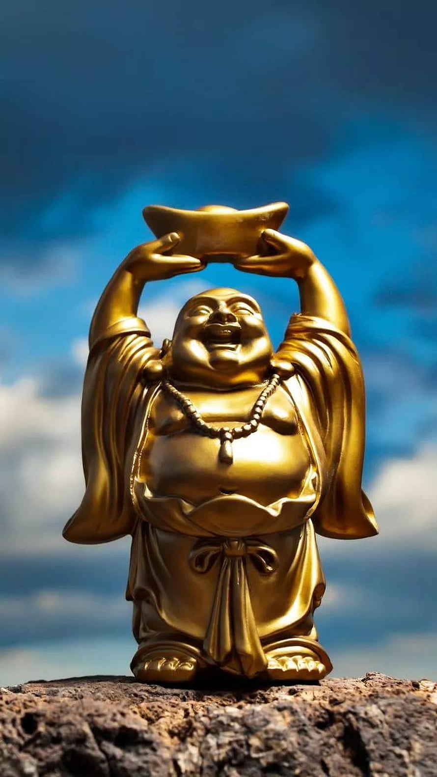 Golden Laughing Buddha Statue Holding Ingot Against Blue Sky HD phone wallpaper