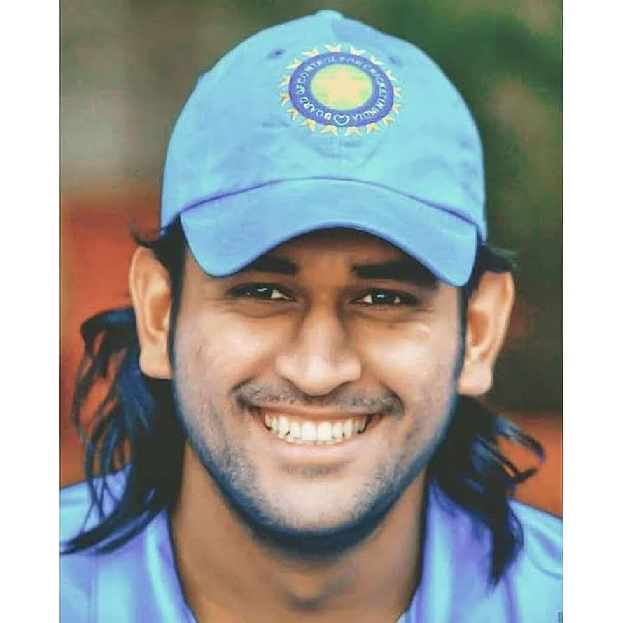 M.S. Dhoni smiling portrait wearing Indian cricket team cap with long hair HD phone wallpaper