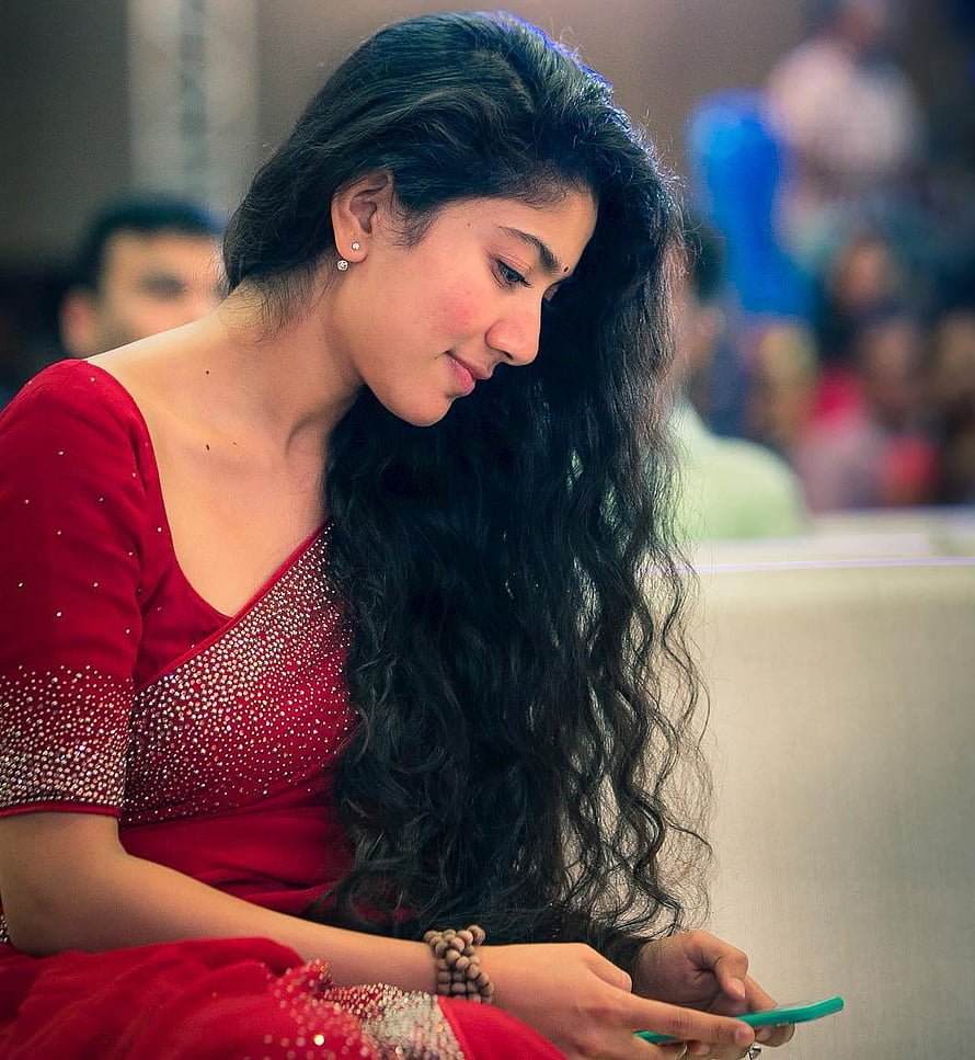 Sajal Aly in a Red Embellished Dress Looking at Phone HD phone wallpaper