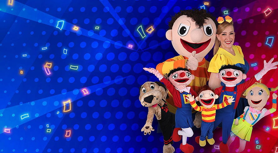 The Wiggles cast and puppets posing together on a colorful blue background with neon confetti HD wallpaper
