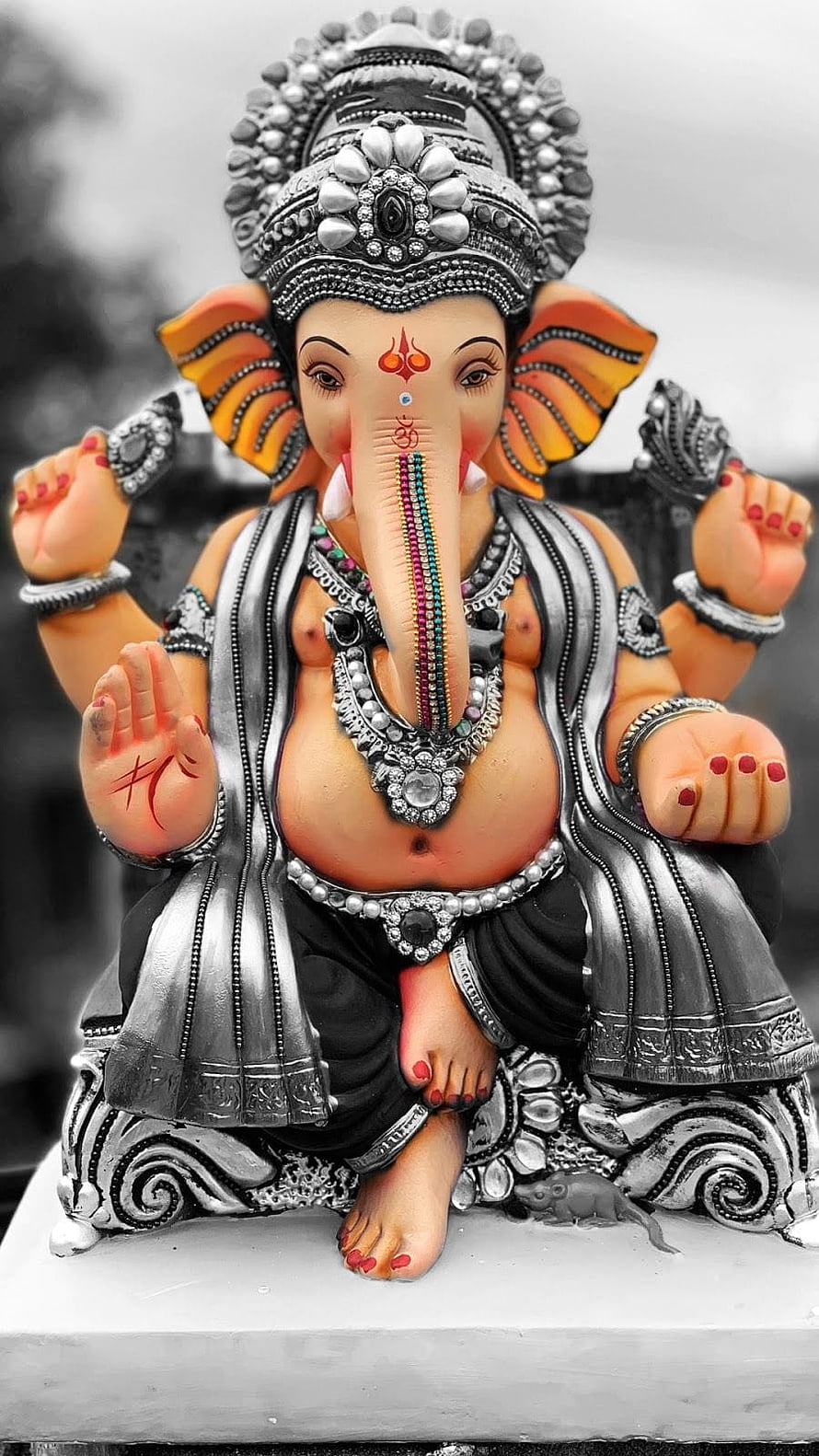 Ornate Silver Ganesha Statue with Colorful Accents and Intricate Jewelry Details HD phone wallpaper