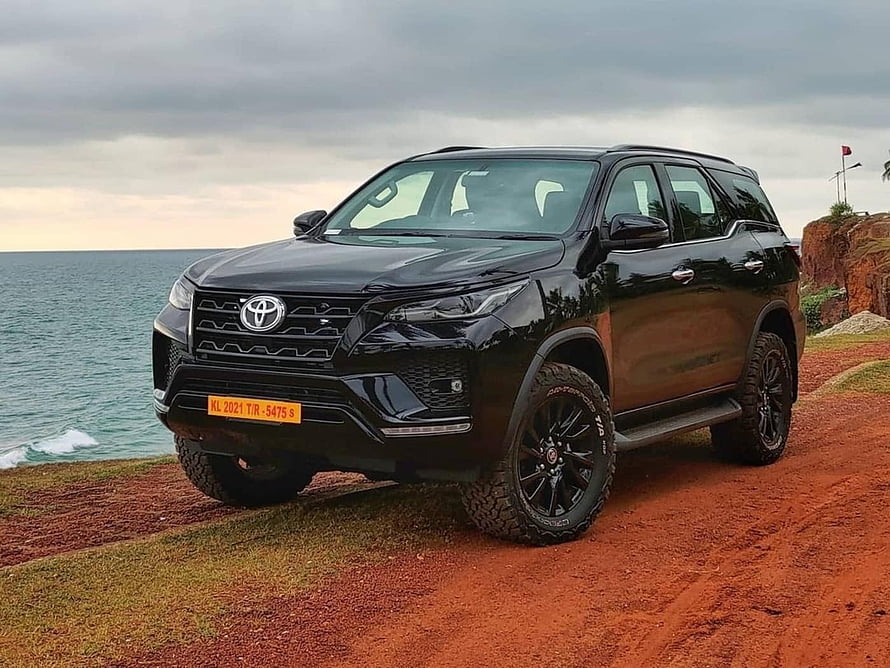 Black Toyota Fortuner Off-Road SUV Parked on Red Dirt Cliff by Ocean HD wallpaper