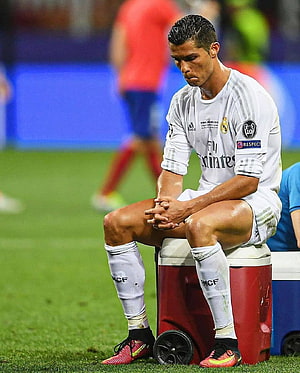 Cristiano Ronaldo sitting dejected on a cooler during a Real Madrid match HD phone wallpaper
