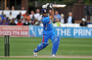 Sachin Tendulkar in Blue India Kit Executing a Powerful Cricket Shot HD wallpaper