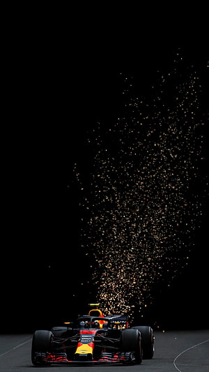 Red Bull Racing Formula 1 car emitting sparks on a dark track HD phone wallpaper