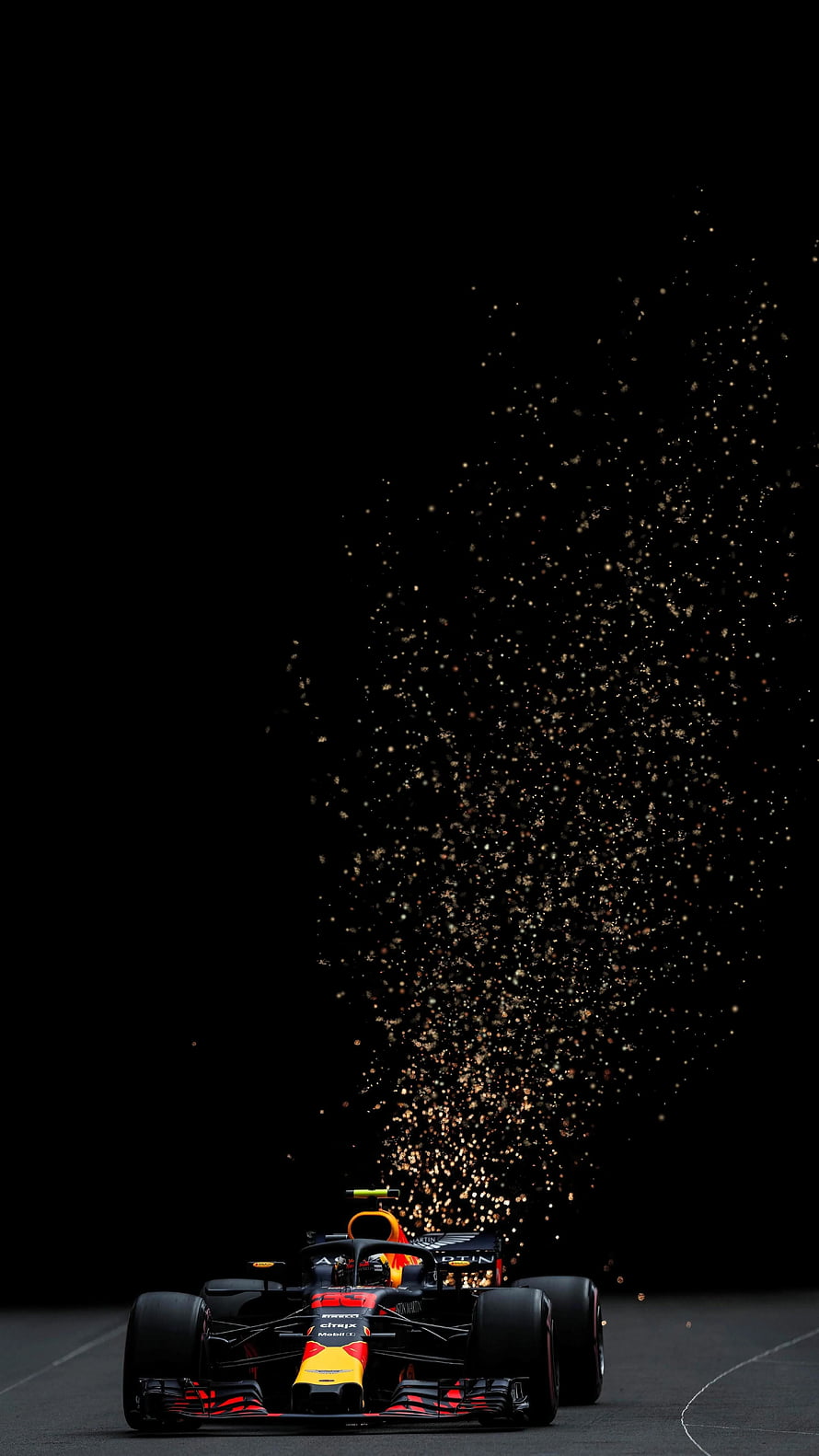 Red Bull Racing Formula 1 car emitting sparks on a dark track HD phone wallpaper