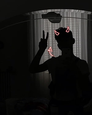 Silhouette of a person with glowing red devil horns and a peace sign in a dark room HD phone wallpaper