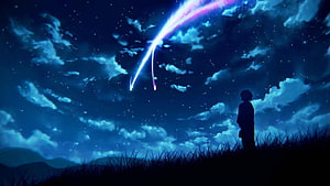 Silhouette of a person watching a glowing meteor streak across a starry night sky HD wallpaper