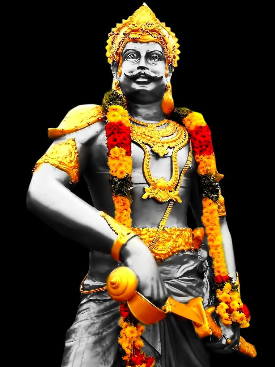 Statue of Karna from Mahabharata adorned with golden ornaments and flower garlands HD phone wallpaper