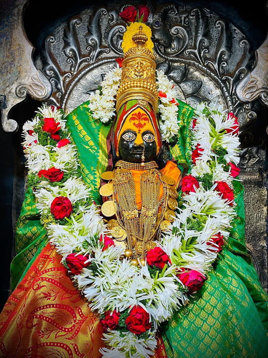 Ornate Hindu Goddess Statue Adorned with Gold Jewelry and Flower Garlands HD phone wallpaper