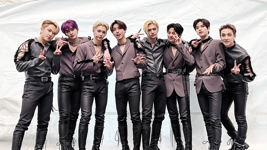Stray Kids in coordinated leather suits and taupe blazers posing against a white backdrop HD wallpaper